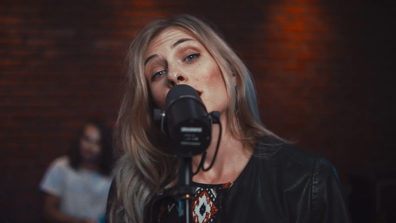 Canary singing close to the microphone, looking directly at the camera