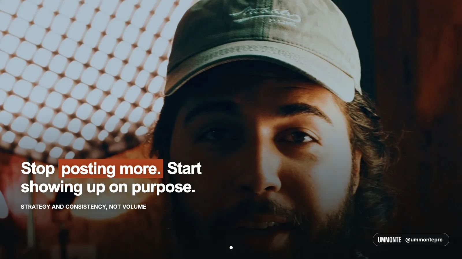 Stop posting more, start showing up on purpose, in bold white type with posting more highlighted in orange, over a glowing softbox in a dark room